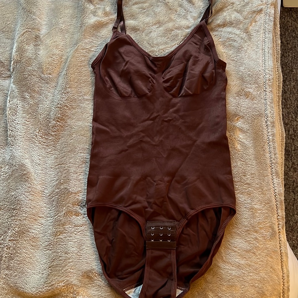 Form fitting body suite